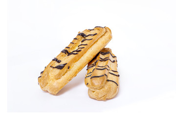 Eclairs with chocolate on white background