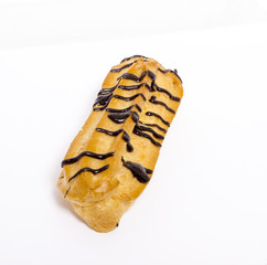 Eclairs with chocolate on white background