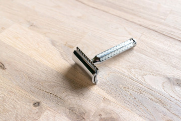 vintage chrome plated razor on a grain oak tree background