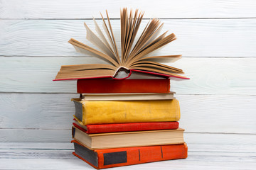 Open book, hardback books on wooden table. Back to school. Copy space