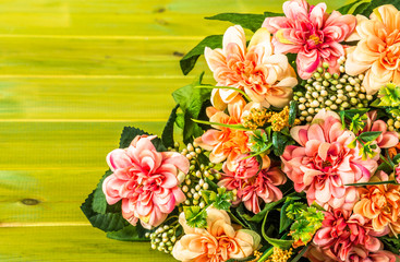 Flowers mixed bouquet on wood. Background with copy space useful as greeting card.