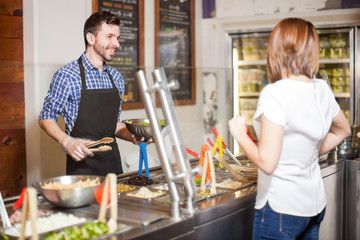 Man making a salad for a customer