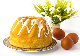 Easter breakfast table with easter cake (bread) and flowers
