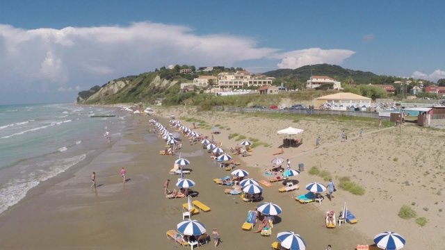 Aerial view of people enjoying on the Corfu sandy beach
