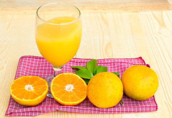 Organic orange fruit. Slices on soft wooden background