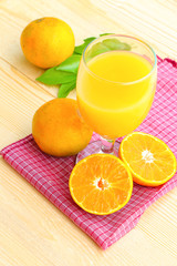 Organic orange fruit. Slices on soft wooden background