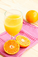 Organic orange fruit. Slices on soft wooden background