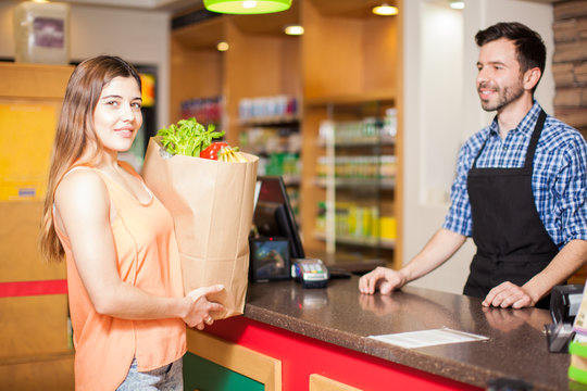 Woman At Checkout Counter In A Grocery Store