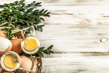 Eggs in easter basket on wooden background.