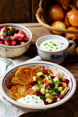 potato fritters with herring and vegetables