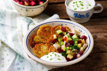 potato fritters with herring and vegetables