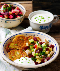 potato fritters with herring and vegetables