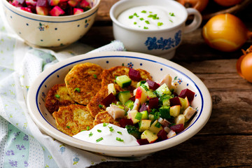 potato fritters with herring and vegetables