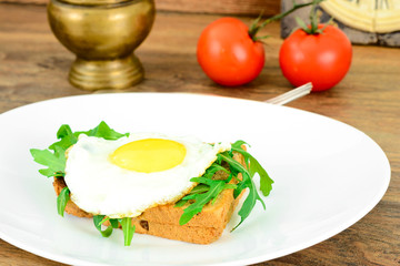 Scrambled Eggs with Arugula on Whole Grain Bread Health Food.