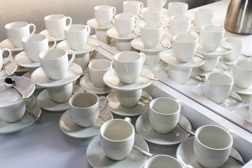 Coffee cups lined up in cafeteria or coffee house