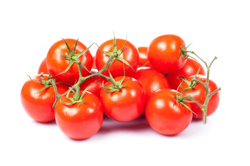 fresh tomatoes with green leaves isolated on white background