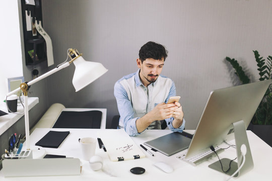 Handsome businessman working in office using mobile phone