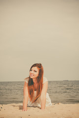 Fototapeta na wymiar Red haired girl outdoor on beach