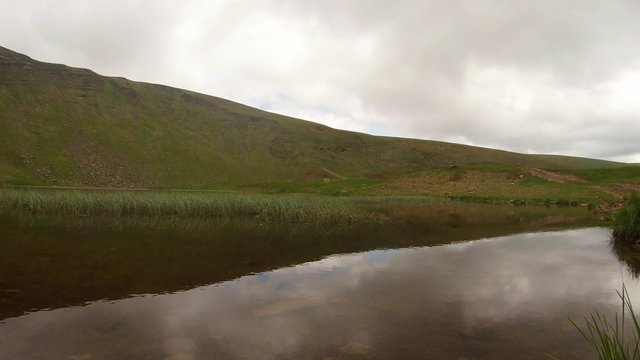 The slope of a small hill that is located near the mountain lake