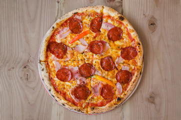 Pizza with sausage, bacon and pepperoni - Top view