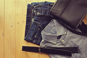 Man items, clothing flat on wood background