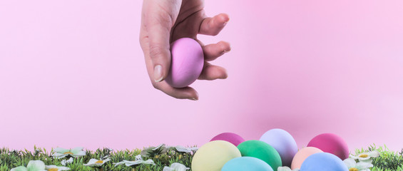 Female hand grabbing painted Easter egg letterbox