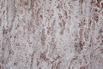 Close-up Detail Of Cracked Paint With Red Traces Of Water Stain On Wall.