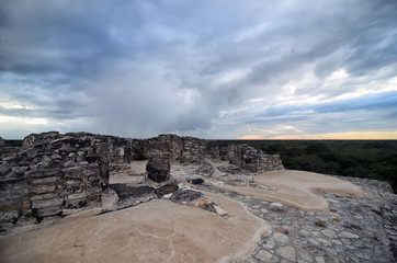 Fototapeta na wymiar Top of Mayan pyramid under tragic stormy sky 