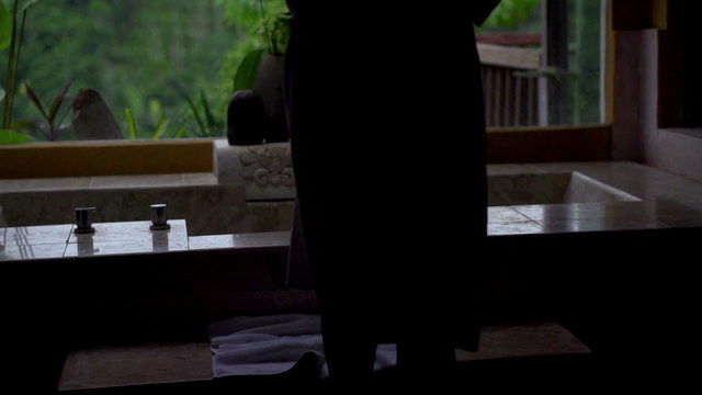 Young woman taking off bathrobe and taking bath in the bathroom, 240fps
