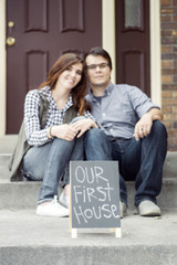 couple outside of new home celebrating new purchase