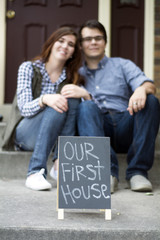 couple outside of new home celebrating new purchase