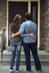 couple outside of new home celebrating new purchase