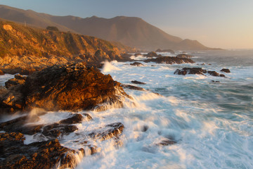Sunset light and waves crashing on Big Sur coast, central California, United States of America