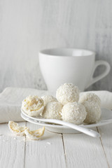 Coconut candies pile in white plate and cup