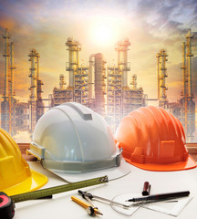 engineer working table plan, and oil refinery plant in heavy pet