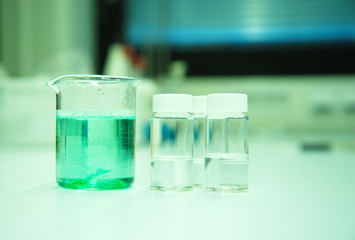 green solution in beaker in science lab