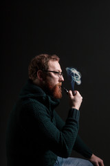 A man with a red beard with a pipe
