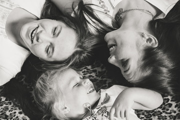 Fototapeta premium Top view of young sisters girls laughing happily