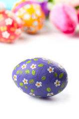 Easter eggs and flowers on white