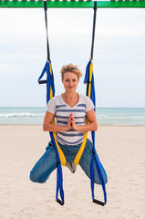 Fly-yoga on the beach. Yoga with hammock by The sea.