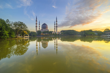 Fototapeta na wymiar The Beautiful Sultan Salahuddin Abdul Aziz Shah Mosque (also known as the Blue Mosque) with nature sunrise lighting and reflection..