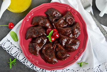 Chocolate dumplings with cherries a beautiful red plate