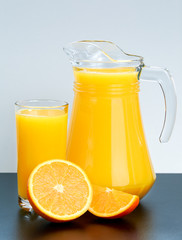 Glass and pitcher of fresh orange juice