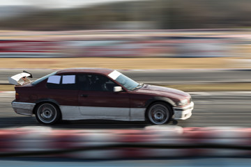 Obraz na płótnie Canvas Car moving fast on the track