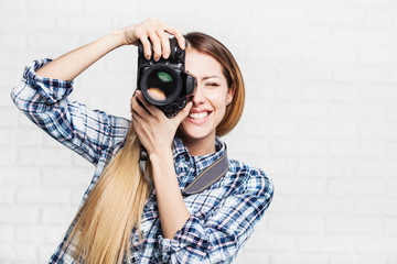 Woman photographer takes images with dslr camera