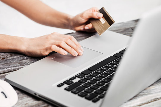 Hands holding credit card and using laptop. Online shopping concept