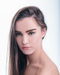 Portrait of beautiful girl with brown hair on white background