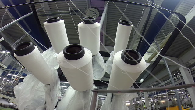 Yarn Spools in a Textile Factory / Small group of yarn spools in a textile mill close up. HD1080p.