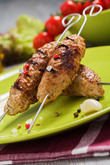 Barbecued kofta - kebeb with vegetables on a plate.