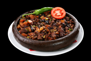 Turkish stew with vegetables on traditional plate / Sacta türlü - Dark background
